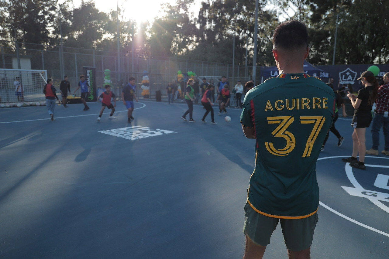 LA Galaxy midfielder, Daniel Aguirre  watches boys and girls from Jordan High Schoolâs soccer team participate in clinic, running drills led by LA Galaxy coaches on the new mini-pitch field at DeForest Park in Long Beach, Calif. The new mini-pitches were made possible by Herbalife Nutrition, LA Galaxy and the U.S. Soccer Foundation to encourage youth to stay healthy and active, and also providing them with a safe place to play.